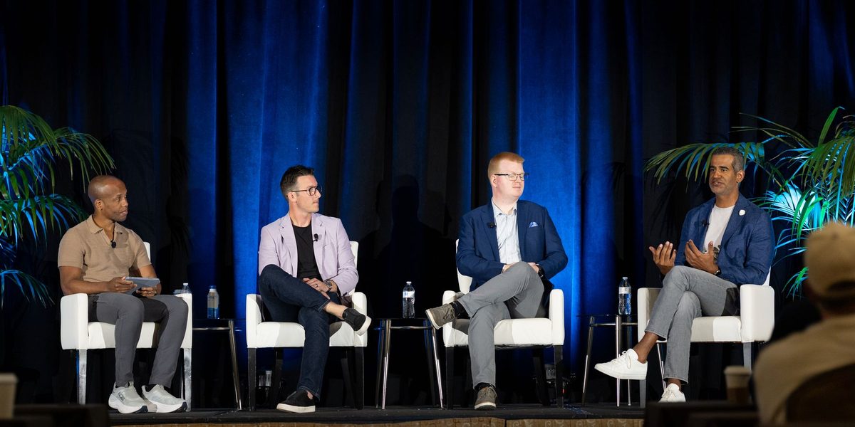 Daniel Paulino, seated at right, speaking on a panel at AIM